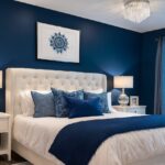 Elegant navy blue and white bedroom with tufted headboard, crystal chandelier, and luxury decor.