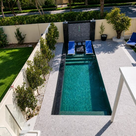 Overflow pool project at Springs by leading swimming pool companies in Dubai, featuring modern design, lounge chairs, and landscaping