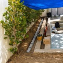 Swimming pool and landscaping companies in Dubai completing villa landscaping with edging and patio construction